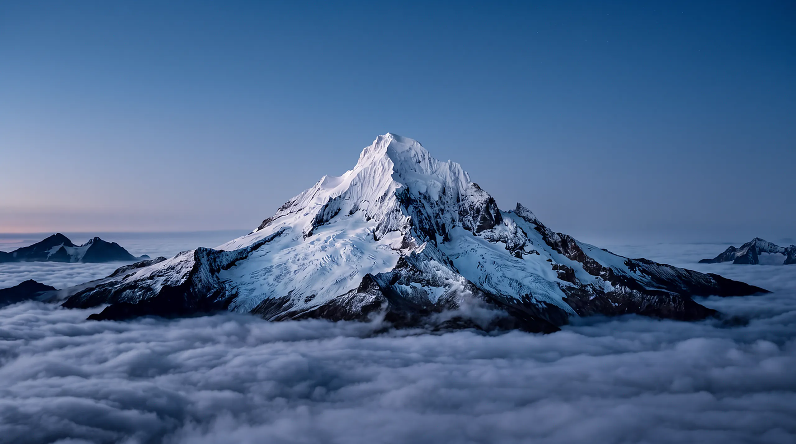 The same summit at blue hour, stars above, the cloud sea gone dim